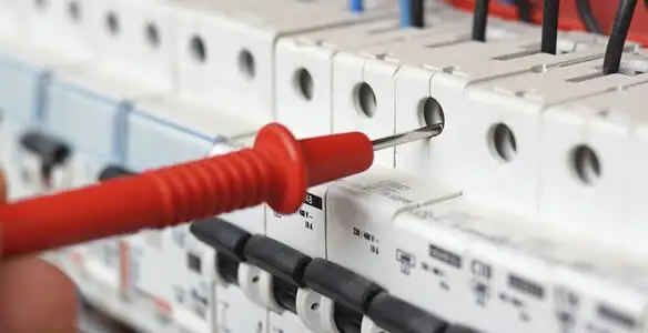 Electrical contractor testing circuit breakers during electrical repair in Grandville, MI