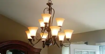 Classic ceiling chandelier installation with warm lighting in Grand Rapids, MI