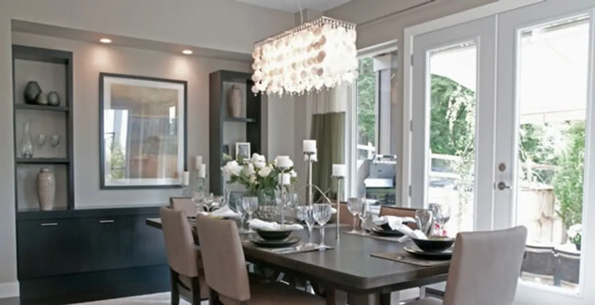 Elegant dining room chandelier installation above table in Grand Rapids, MI