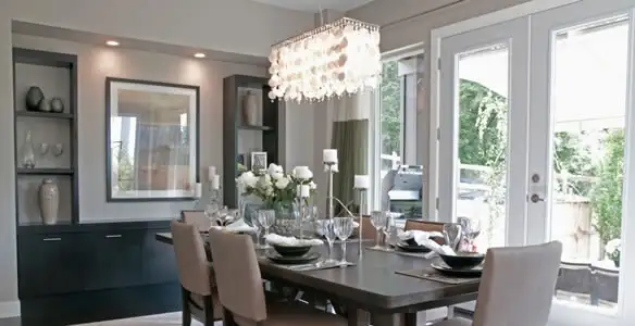 Elegant dining room chandelier installation above table in Grand Rapids, MI