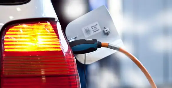 Electric car plugged into EV charger after professional installation in Grand Rapids, MI