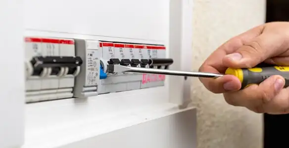 electrical panel upgrade service showing technician adjusting circuit breakers during system upgrade in Grand Rapids, MI