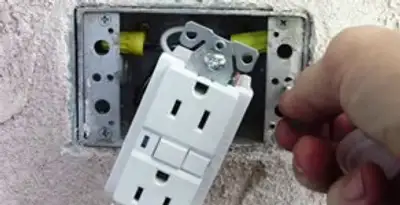 gfci circuits service showing installation of a ground fault circuit interrupter outlet by licensed electricians in Grand Rapids, MI