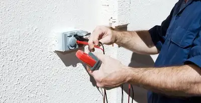 Electrician performing home electrical outlet and wiring inspection in Grand Rapids, MI