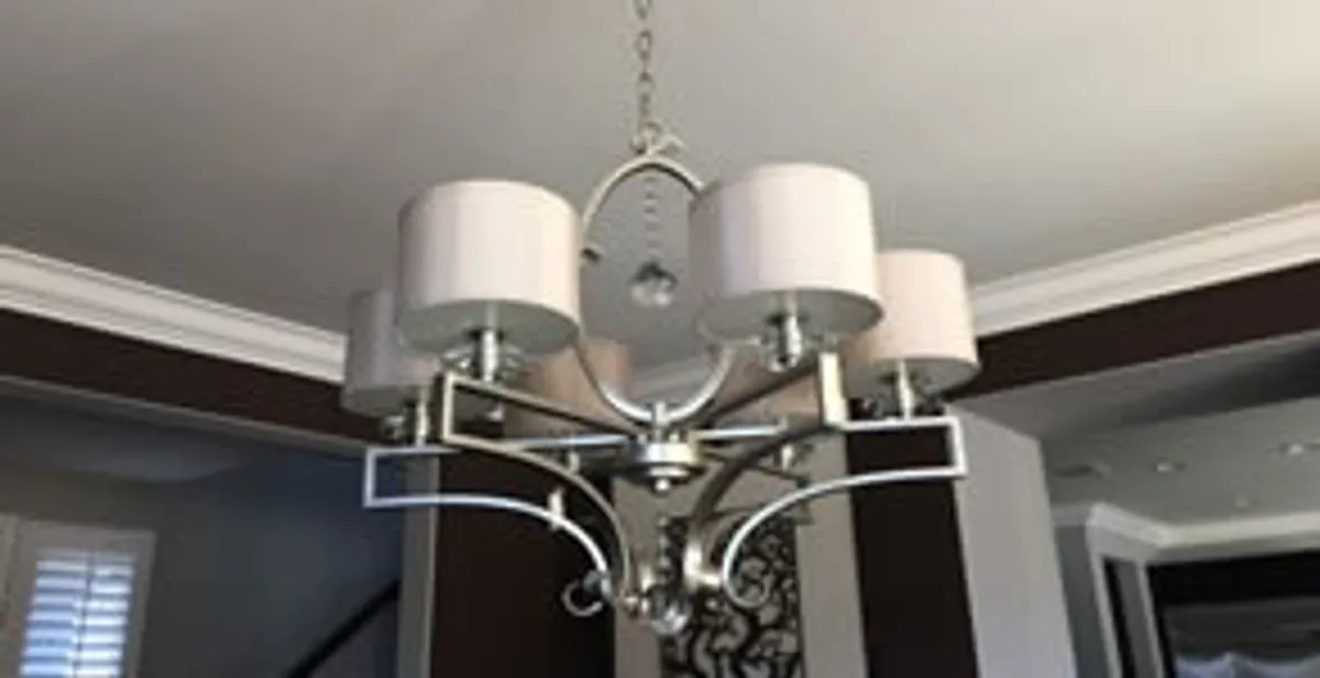 Modern chandelier installation with multiple light fixtures in Grand Rapids, MI