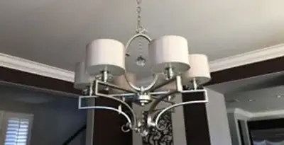 Modern chandelier installation with multiple light fixtures in Grand Rapids, MI