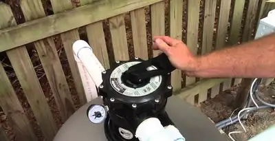 pool pumps service showing professional adjustment of pool pump control system in Grand Rapids, MI