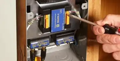 Whole home surge protection device being installed by a licensed electrician to protect electrical systems in Grand Rapids, MI